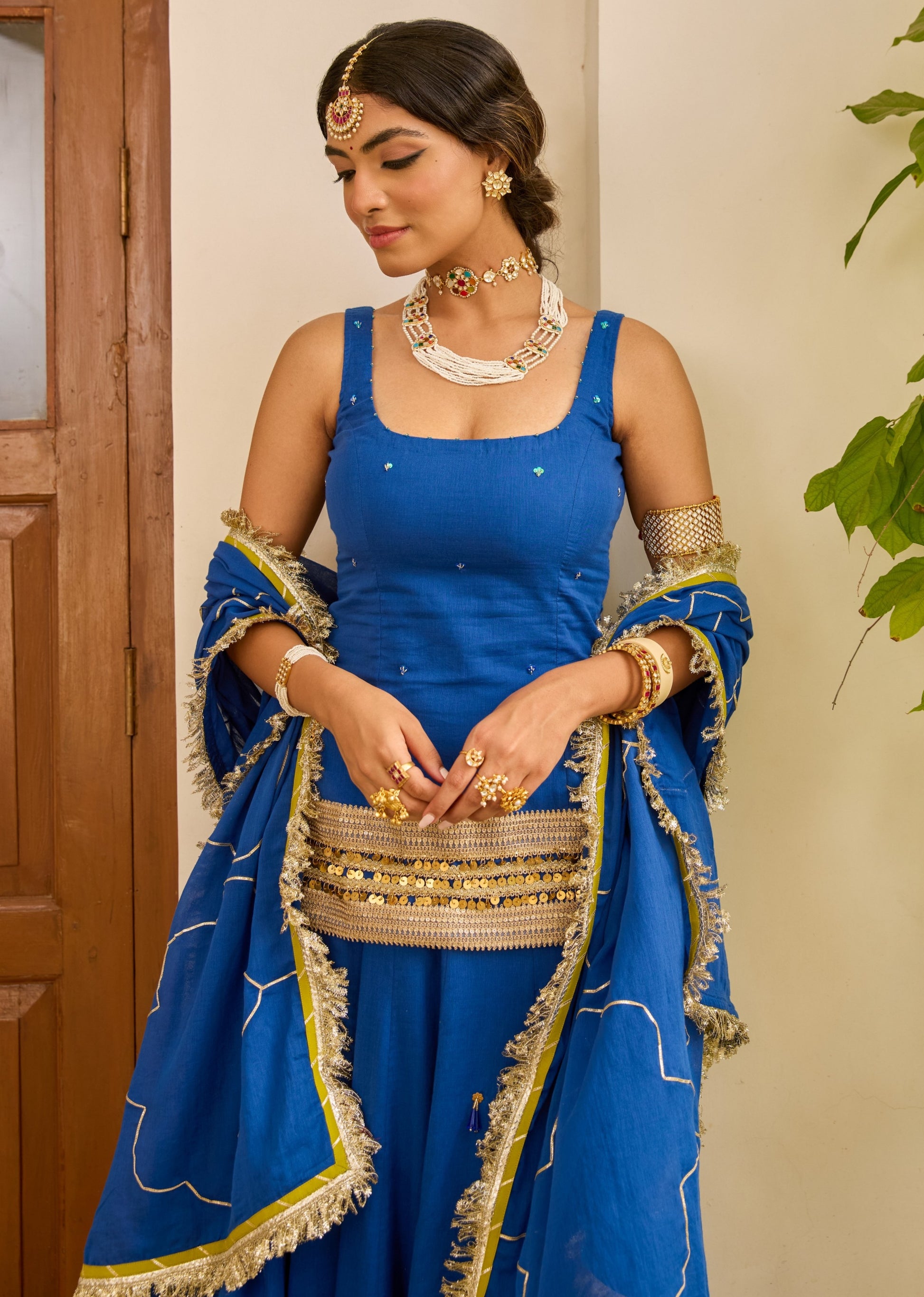 Royal blue festive skirt set with sleeveless short kurta and handcrafted mulmul dupatta for wedding events by JOVI India